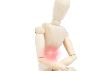 Close-up of a wooden man on white background with stomach pain. Painful illness and intestinal discomfort. Abdominal pain. Hernia. Concept of pain.