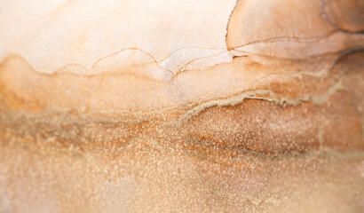 Abstract art with bronze, silver and gold background, smudges and stains made with alcohol ink.
