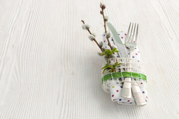 Table setting with fork, knife and willow branches for Easter, birthday or mother's day.