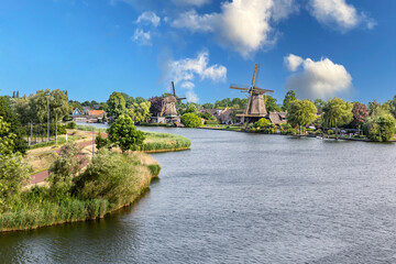Historic wooden windmill on the canal bank in the Netherlands