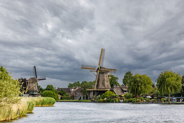 Historic wooden windmill on the canal bank in the Netherlands