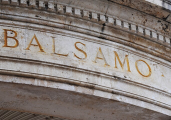 The Italian word 'balsamo' (baume) carved and painted in golden letters on ancient ornate round marble wall