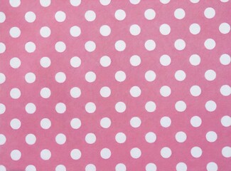 Seamless white polka dot pattern on pink background