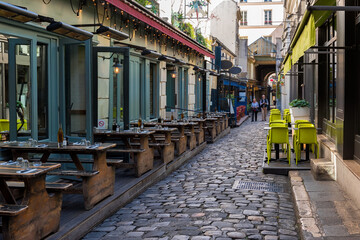 Cozy street near Boulevard San-German with tables of cafe  in Paris, France. Cityscape of Paris. Architecture and landmarks of Paris - 751836389