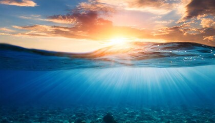 blue sea or ocean water surface and underwater against sunset - obrazy, fototapety, plakaty