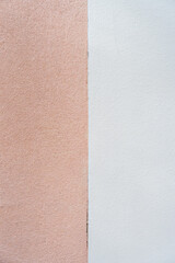 Fototapeta premium Fascinating position of two distinct wall textures and colors. Left side rough, brown texture while right side presenting smooth, white surface. Clear straight line separating them