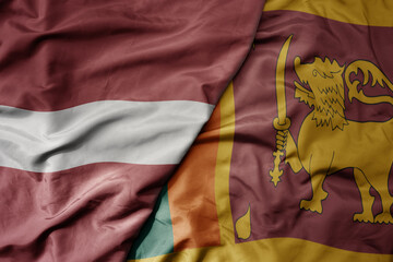 Fototapeta premium big waving national colorful flag of sri lanka and national flag of latvia.