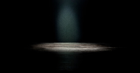 An empty dark stage with a light in the centre. An advertising concept for your product.