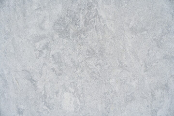 Sleek grey surface appearing to be of concrete or stone. Upside characterized by irregular texture and patterns. Concept of wallpapers and wall coverings