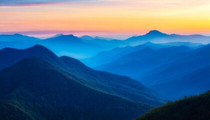beautiful layered blue mountains transitioning into the sunset vetical