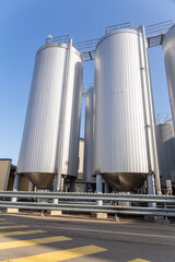 Brewery silos or tanks typically use for storing barley or fermented beer. - obrazy, fototapety, plakaty