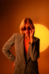 Fashionable portrait of blonde lady in sunglasses posing. 