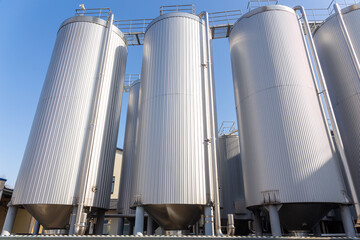 Brewery silos or tanks typically use for storing barley or fermented beer. - obrazy, fototapety, plakaty