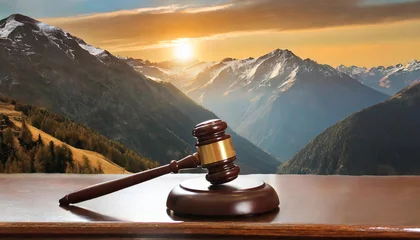 Fototapeten Judges gavel on table against mountain backdrop in natural landscape © tino