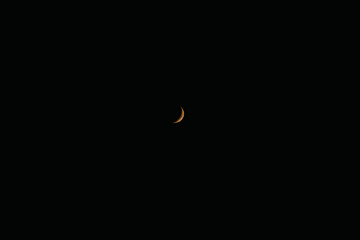 The darkened moon is yellow, eclipse. Crescent moon, moonlit sky, night, darkness. Phase, cycle,...