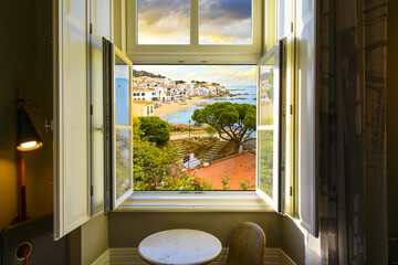 View through an open window of the whitewashed Costa Brava village of Calella de Palafrugell, Spain, as the sun sets on the Catalonian coast of Southern Spain.  © Kirk Fisher