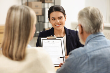 Notary showing senior man where to sign Last Will and Testament in office