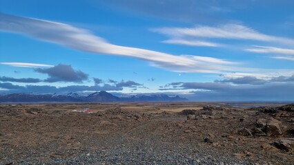 Fototapeta na wymiar Majestic roadside landscape in arctic countryside with farmlands and snowy hilltops in distance, icelandic natural scenery. Spectacular wilderness in nordic environment, scenic route.