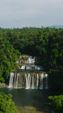 Tropical forest and jungle with waterfalls. Tinuy-an Falls in Bislig, Surigao del Sur. Philippines. Vertical view.