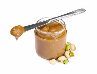 Tasty nut paste in jar, knife and pistachios isolated on white