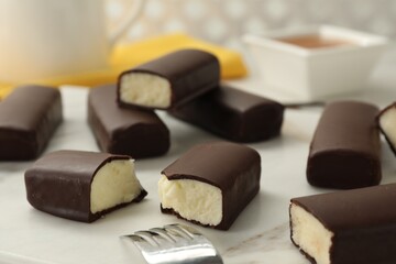 Glazed curd cheese bars on white board, closeup