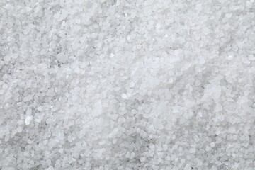 White natural salt as background, top view