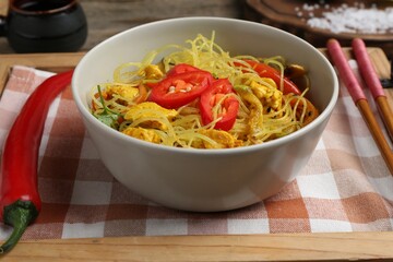 Stir-fry. Tasty noodles with vegetables and meat in bowl on table