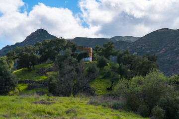 Views mountains, hills, rivers, lush grass and foliage, while hiking during the spring in Malibu Creek State Park.