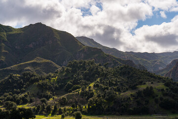 Views mountains, hills, rivers, lush grass and foliage, while hiking during the spring in Malibu Creek State Park.