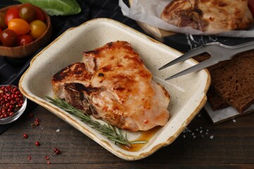 Tasty marinated meat, rosemary and spices on wooden table, closeup