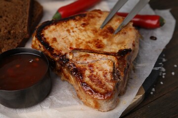 Tasty grilled meat, chili and marinade on table, closeup