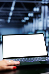 Close up shot of mock up laptop used by admin in server room delivering massive computing power,...