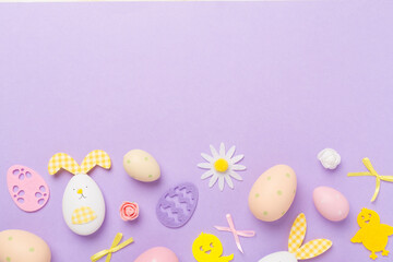 Fototapeta na wymiar Easter eggs and decoration on color background, top view
