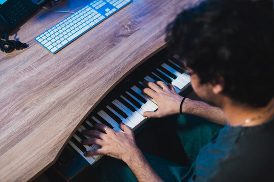 Musician playing keyboard during studio session