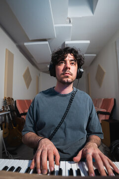 Musician concentrating on keyboard during studio session