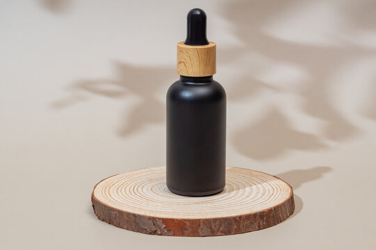 Elegant skincare serum bottle on wooden swatch