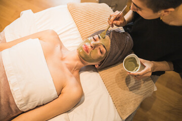 Relaxing facial treatment at a spa with a clay mask