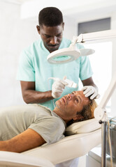 Fototapeta premium Skilled dermatologist used skin scrubber attachment to gently exfoliate patient's skin, revealing smoother complexion.