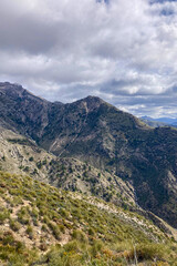 Fototapeta na wymiar Panoramic view from hiking trail to Maroma peak in thunderstorm day, Sierra Tejeda, Spain 