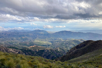 Fototapeta premium Panoramic view from hiking trail to Maroma peak in thunderstorm day, Sierra Tejeda, Spain 
