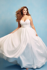 Fototapeta na wymiar Young redhead full-figured bride in a flowing white wedding dress in blue backdrop. Concept of bridal joy, natural beauty, grace, femininity, and elegant simplicity.