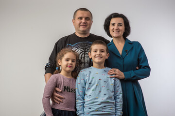 studio portrait of a happy family husband wife daughter and son 2