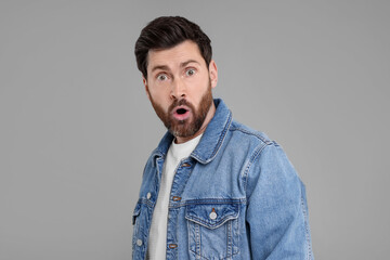Portrait of surprised man on grey background