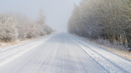 snowy country road with fog