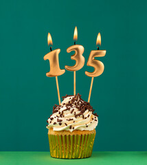 Birthday card with candle number 135 - Green background