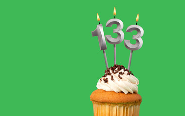 Birthday card with candle number 133 - Cupcake on green background