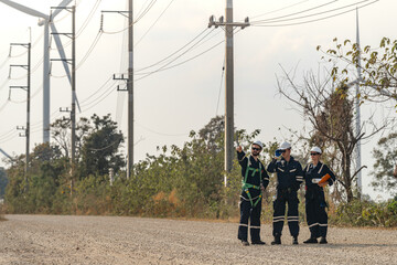 engineer working in fieldwork outdoor. Workers check and inspect construction and machine around building project site. Wind turbine for electrical of clean energy and environment sustainable.