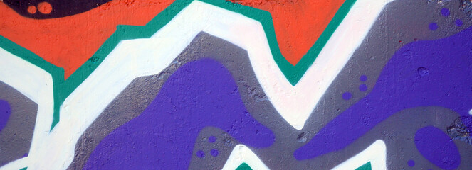 Colorful background of graffiti painting artwork with bright aerosol outlines on wall. Old school...
