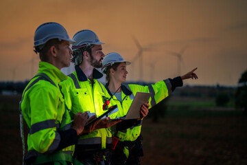 Team Engineers men and woman checking and inspecting on construction with sunset sky. people...