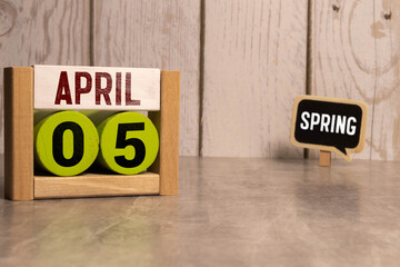 Day 5 of April month, Wooden calendar with date on the desk.